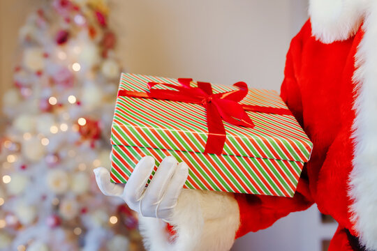 Santa Claus is getting ready for Christmas, he is holding a children's gifts. Christmas decoration.