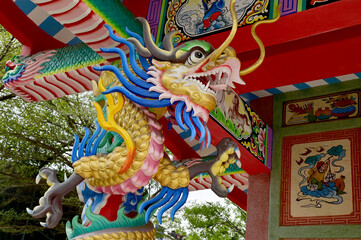 Fototapeta premium Closeup of Tha Colorful Dragon Decoration On the black wall background at Thai Temple at Thailand.