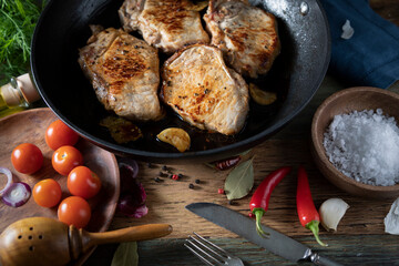 Grilled meat in a cast iron pan on a rustic table