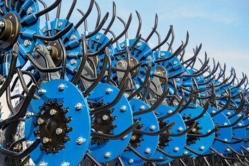 Closeup of a rotary harrow for processing an agricultural field.