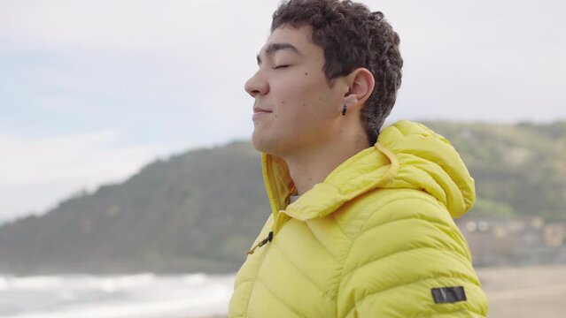 Hispanic teenager boy breathing deep outdoors