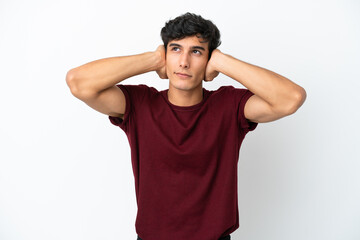 Young Argentinian man isolated on white background frustrated and covering ears