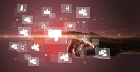 Hand pressing social media multimedia application screen with media icons on futuristic concept