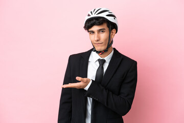 Argentinian businessman with bike helmen isoleted on pink background