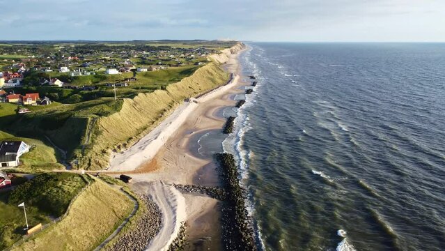 Aerial drone view of the idyllic coast line in Denmark around the village of L&oslash;nstrup on a summer day	
