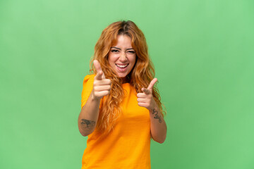 Young caucasian woman isolated on green screen chroma key background pointing to the front and smiling - Powered by Adobe