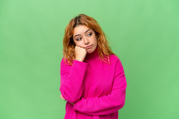 Young caucasian woman isolated on green screen chroma key background with tired and bored expression
