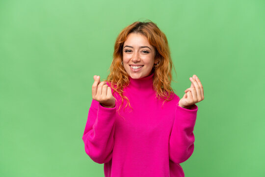 Young Caucasian Woman Isolated On Green Screen Chroma Key Background Making Money Gesture