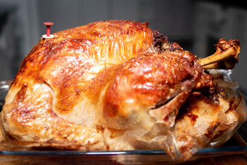 Roasted Christmas turkey with ready indicator device. Closeup and selective focus