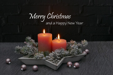 Christmas card: Christmas greetings with pink candles and Christmas baubles. Merry Christmas and a Happy New Year.