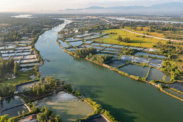 Fototapeta premium Aerial view of the Shrimp ( Prawn ) farm with aerator pump in Tam Ky, Quang Nam, Vietnam. The growing aquacuture business continuously for export to China, Korea, Japan, Americ