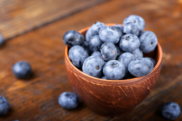 Freshly picked blueberries in  bowl. Bilberry on wooden Background. Blueberry antioxidant. Concept for healthy eating and nutrition