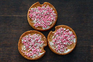  Traditional dutch treat eaten to celebrate the birth of a baby girl called beschuit met muisjes which consists of rusk with white and pink sugary anise seeds