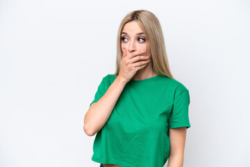 Pretty blonde woman isolated on white background doing surprise gesture while looking to the side