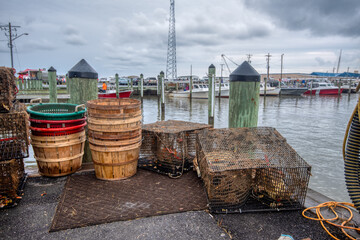 Crab pots and bushel baskets lined up on a Chesapeake Bay pier.