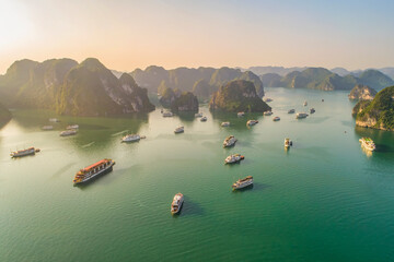 AERIAL VIEW FLOATING FISHING VILLAGE AND ROCK ISLAND, HALONG BAY, VIETNAM, SOUTHEAST ASIA. UNESCO WORLD HERITAGE SITE. JUNK BOAT CRUISE TO HA LONG BAY. POPULAR LANDMARK, FAMOUS DESTINATION OF VIETNAM © Hien Phung