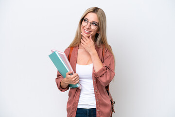 Pretty student blonde woman isolated on white background looking up while smiling