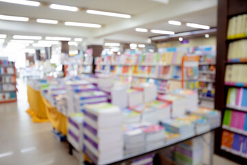 Bloored background of the book store with different books lying on the shelves