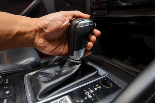 Close-up of a Driver's Hand Changing Gears in an Automatic Transmission Car While Driving a Car