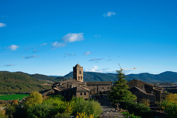 Fototapeta na wymiar Ainsa Sorbrarbe medieval village in the Pyrenees with beautiful stone houses and the slender church tower, Huesca, Spain
