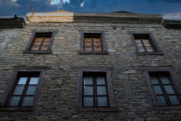 Fototapeta na wymiar Beautiful buildings made of stone, with their charming windows, in the villages of the Aragonese Pyrenees, Spain.