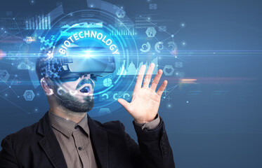 Businessman looking through VR glasses