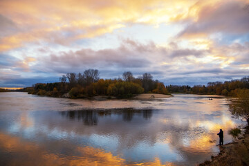 sunset over the lake and fisherman