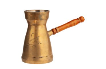 turka, a copper coffee pot with a wooden handle, isolated on a white background