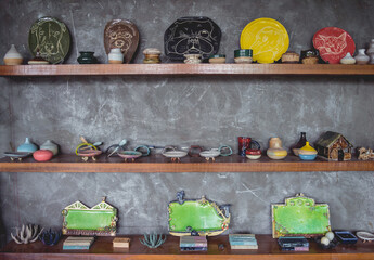 Ceramic toys on the shelves for sale at the workshop