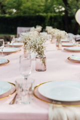 On the table is a decorative vase with dried flowers. Beautiful summer location for relaxation