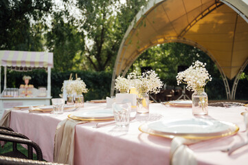 On the table is a decorative vase with dried flowers. Beautiful summer location for relaxation