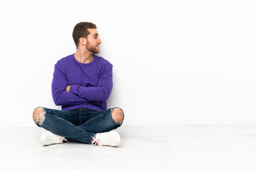 Young man sitting on the floor in lateral position