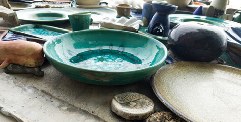 Different colorful ceramic plates on the orange wall