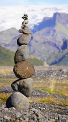 tall cairns in rural iceland with glacier backdrop