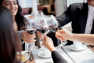 Happiness team young business people in party celebrate success holding glass of wine cheer together at restaurant luxury, friendly and social colleague, meet friend and community concept.