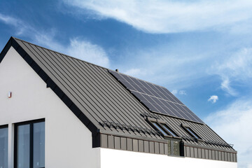 Building with solar photovoltaic panels on metal roof