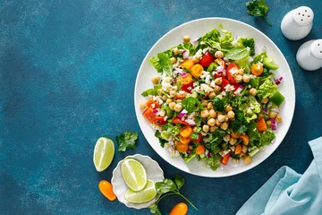 Foto auf Glas Tabbouleh salad. Tabouli salad with fresh parsley, onions, tomatoes, bulgur and chickpea. Healthy vegetarian food, diet. Top view © Sea Wave