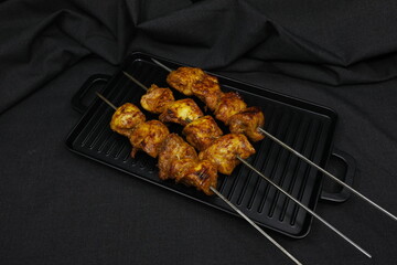Chicken Tikka on black background