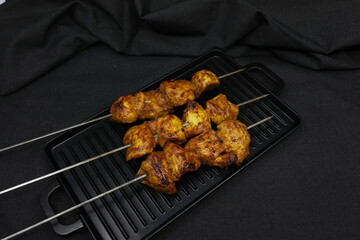 Chicken Tikka on black background