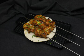 Chicken Tikka on black background