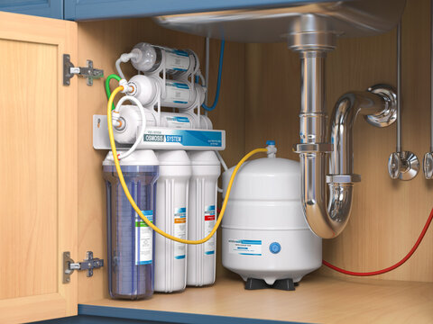Reverse osmosis water purification system under sink in a kitchen.  Water cleaning system installation.