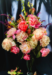 Romantic bouquets of spring flowers with peonies, sage, foxglove, geyhera