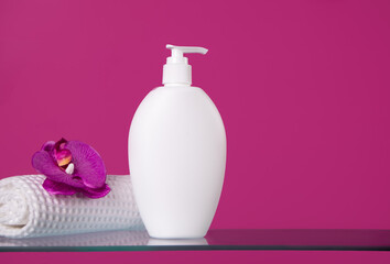 Blank mock up bottle beauty cosmetic skin care organic product for bathing routine with flower frangipani and white towel on purple background. Place your design.