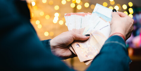 Euro banknotes held in the hands of a man. Concept showing the economic situation in the Eurozone
