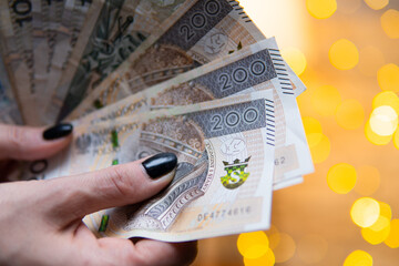 close-up on Polish zloty held in hands by a woman. Polish economy and business