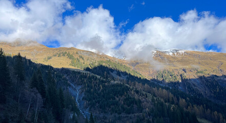 Mystical low autumn clouds and typical mountain fog in Swiss alpine area over the Calfeisental valley, Vättis - Canton of St. Gallen, Switzerland (Kanton St. Gallen, Schweiz)