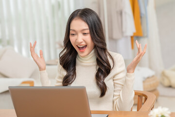 Entrepreneur beautiful business asian young woman working online with laptop and celebrating at home with her work success cheerful and happiness. Small Business Startup concept. Surprise and excite