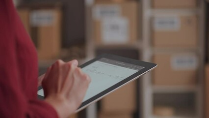 Working on an electronic tablet, keeping records of data from tables of graphs, audi of an e-commerce business online stores delivery service courier service for sending orders
 - Powered by Adobe