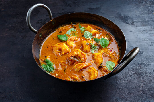 Traditional spicy Indian prawn Madras curry Rogan Josh with king prawns served as close-up in a korei bowl