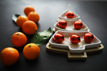 Citrus fruits on a gray background. Tangerines with leaves. Christmas fruit.